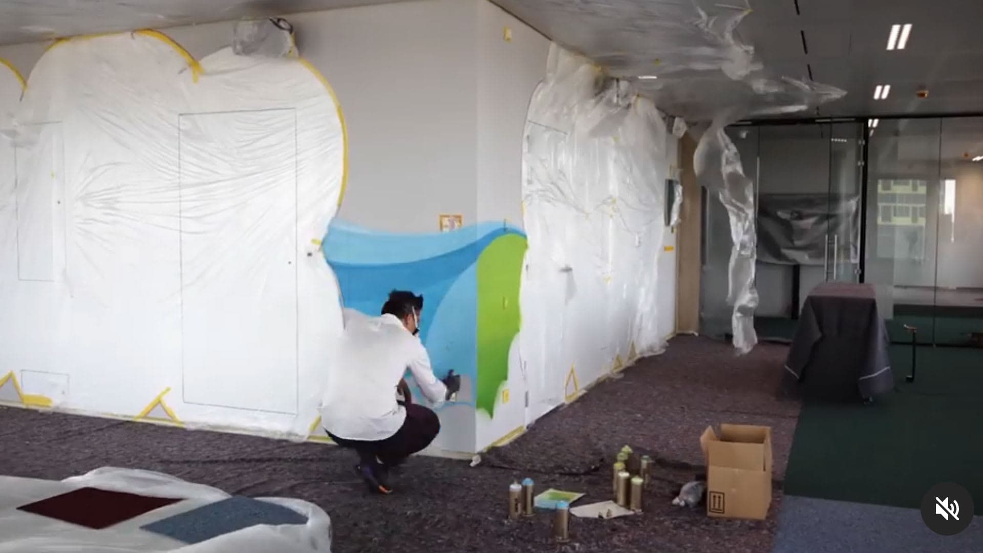 Artist painting a mural in the Deloitte Luxembourg offices